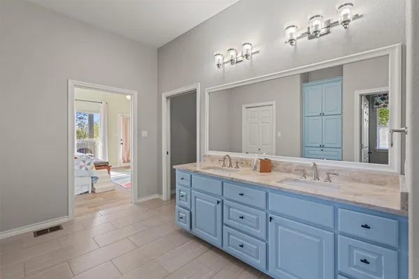 a spacious bathroom with a granite countertop sink a mirror and a