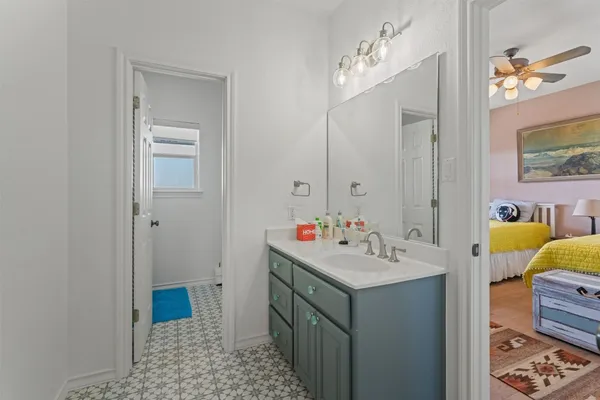 a bedroom with two beds and a window