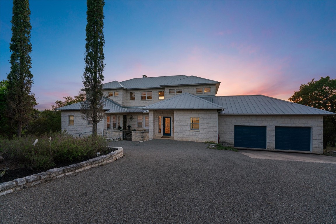 4401 Sunset Cliff Road Burnet, TX 78611 - Photo 3 of 40 a front view of a house with a yard and garage