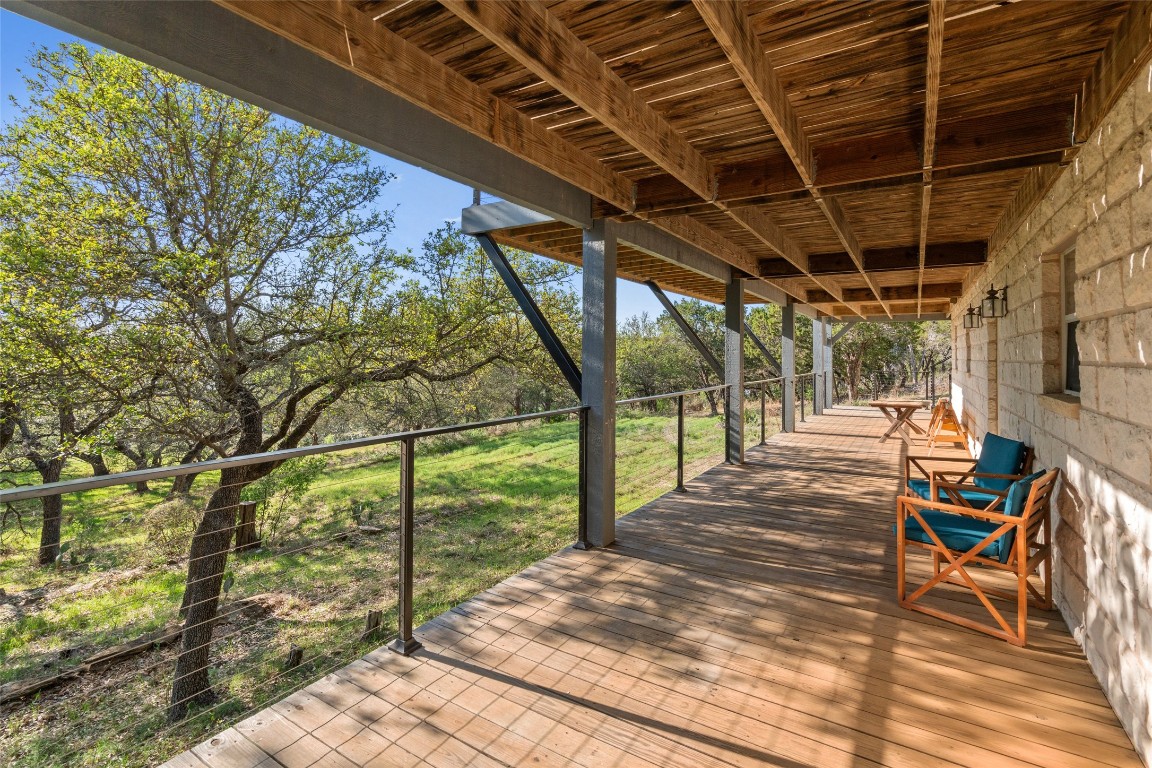 4401 Sunset Cliff Road Burnet, TX 78611 - Photo 31 of 40 a porch with a table and chairs next to a yard