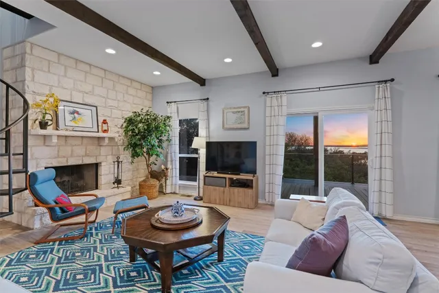 a living room with furniture a fireplace and a flat screen tv