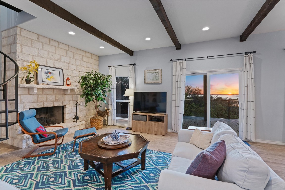4401 Sunset Cliff Road Burnet, TX 78611 - Photo 5 of 40 a living room with furniture a fireplace and a flat screen tv
