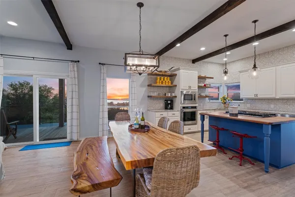 a living room with lots of furniture and kitchen view