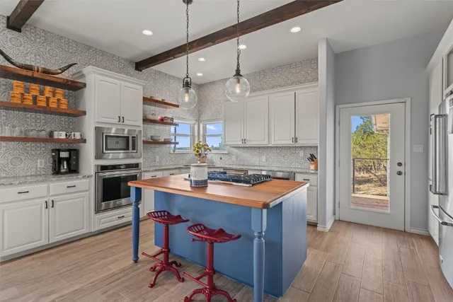 a kitchen with a stove a sink and a refrigerator