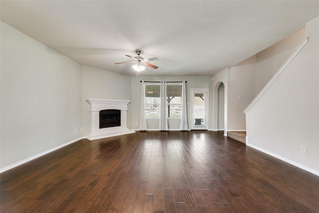 2004 Karsen Lane Heartland, TX 75126 - Photo 3 of 18 an empty room with wooden floor and fireplace