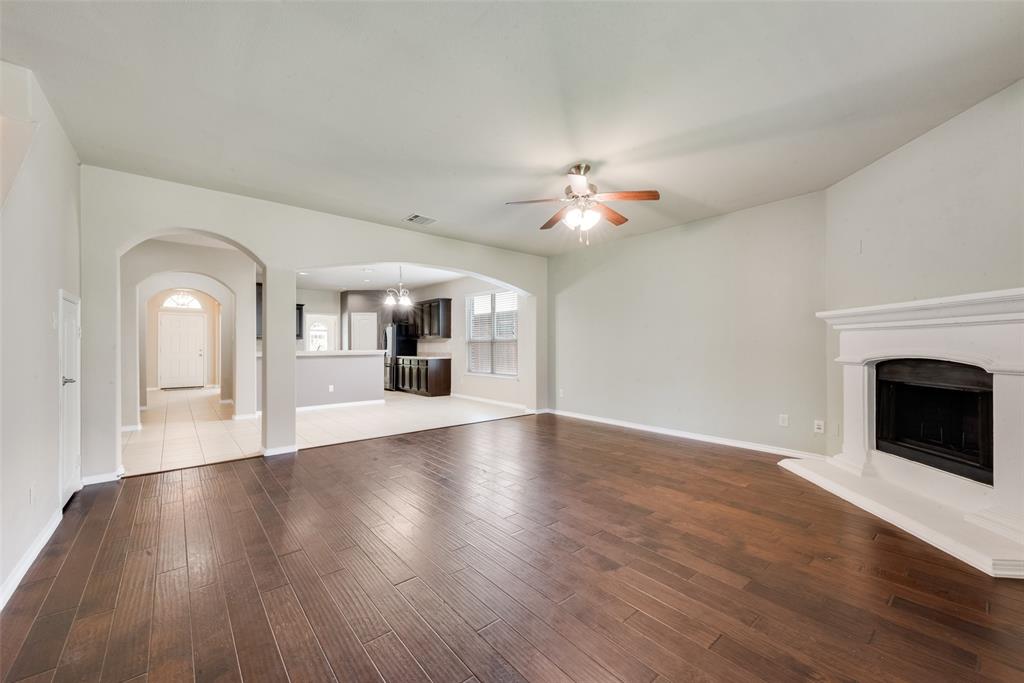 2004 Karsen Lane Heartland, TX 75126 - Photo 4 of 18 a view of a livingroom with wooden floor and a fireplace