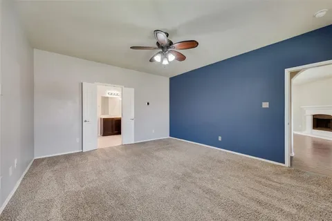 a view of an empty room with a ceiling fan