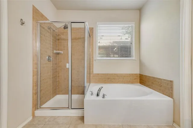 a bathroom with a bathtub and shower
