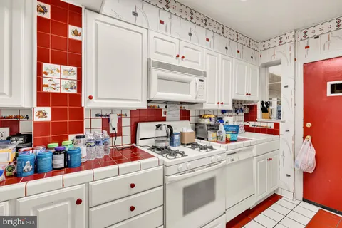 a kitchen with stainless steel appliances a refrigerator and a stove