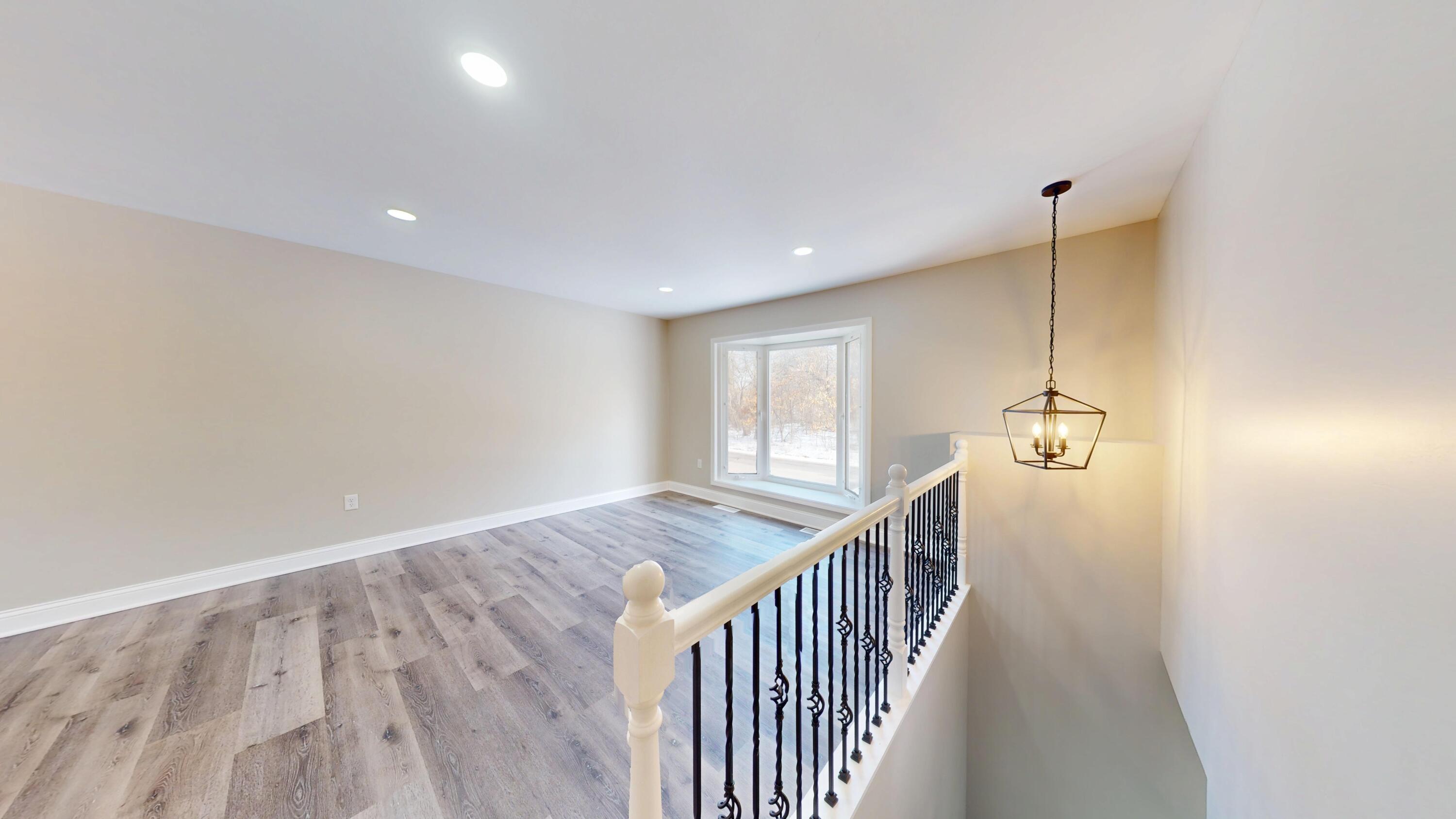 1528 Hanley Street Gary, IN 46406 - Photo 18 of 44 a view of a hallway with wooden floor and windows