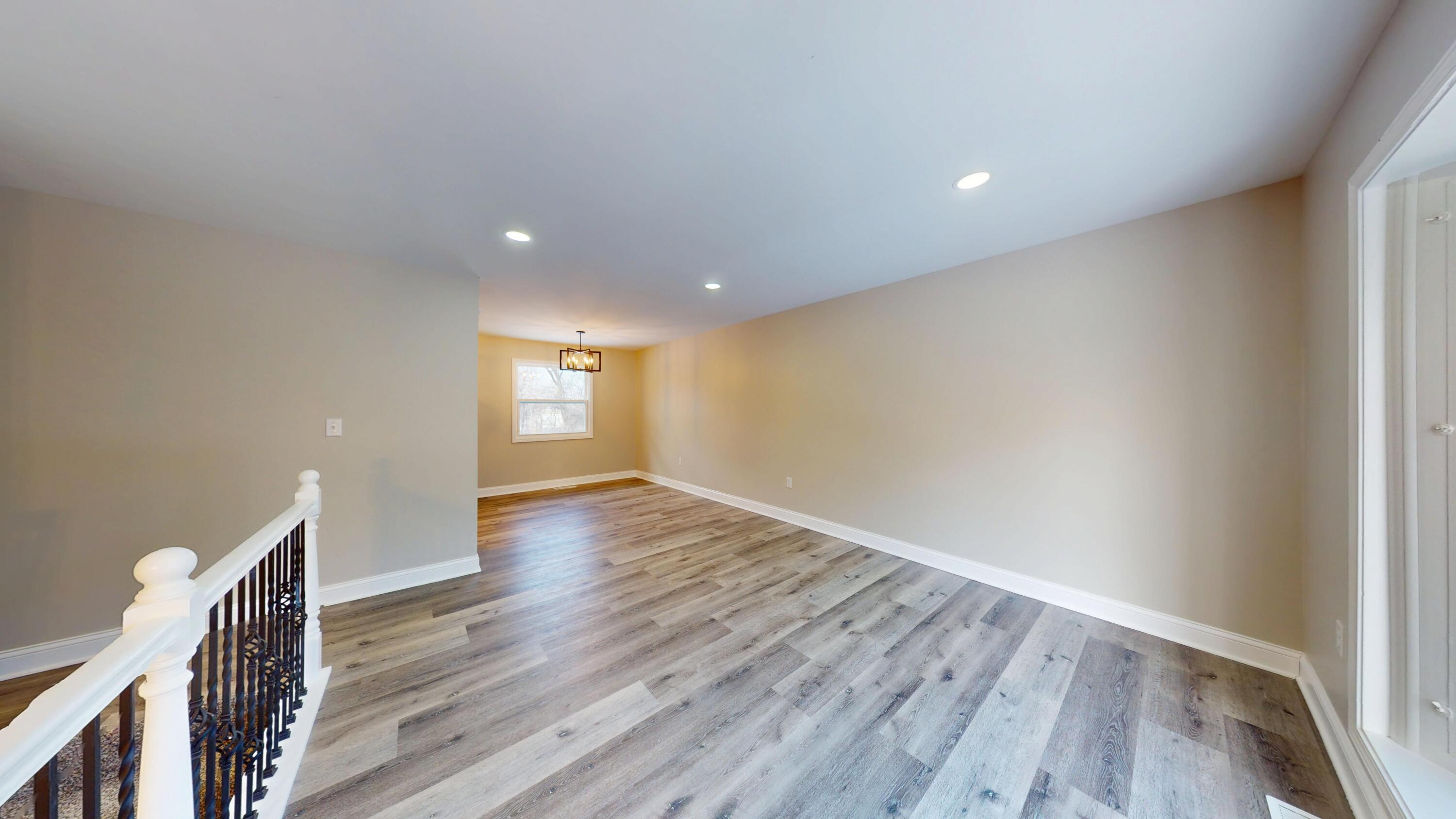 1528 Hanley Street Gary, IN 46406 - Photo 20 of 44 a view of an empty room with wooden floor and a window