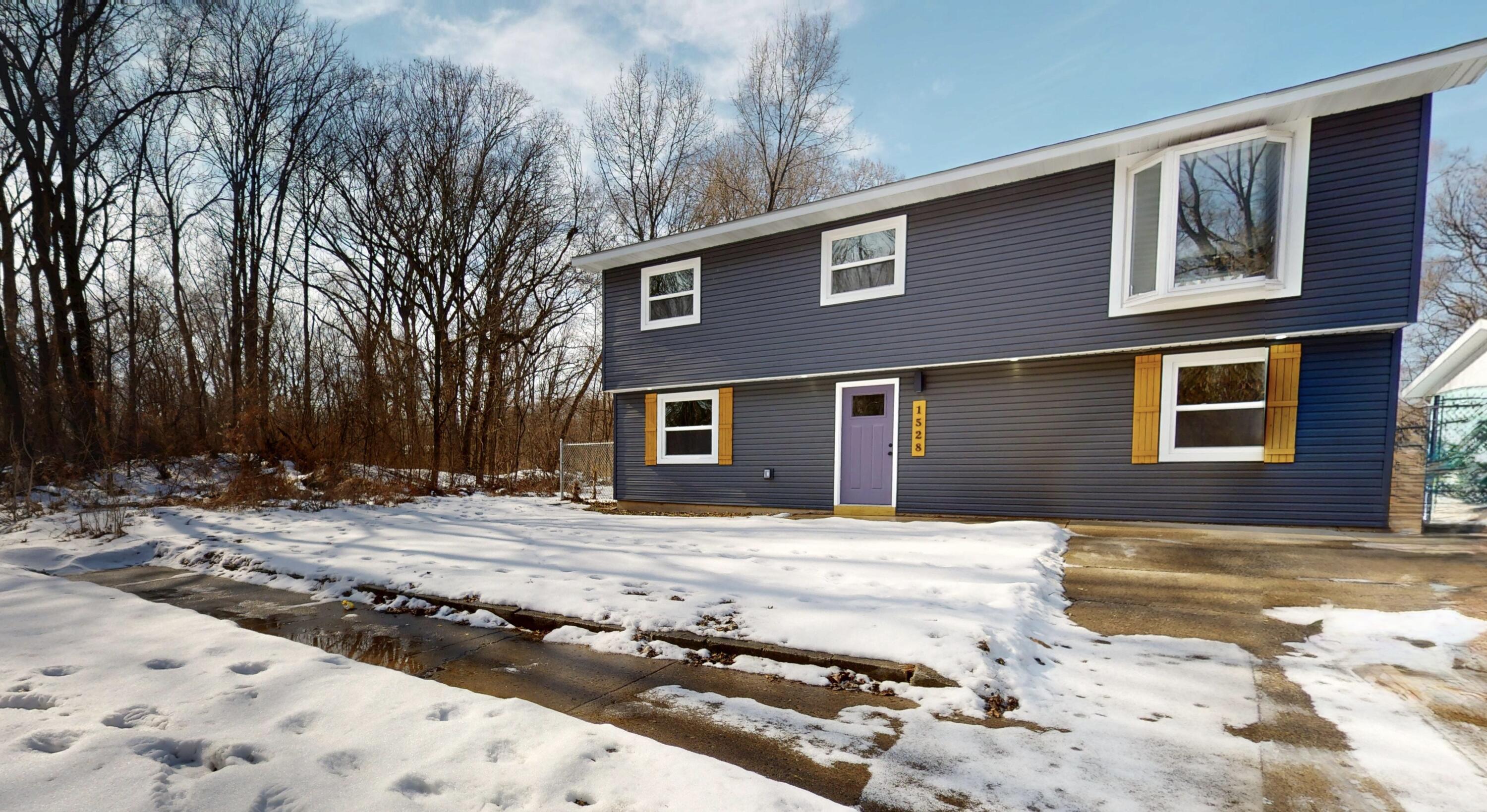 1528 Hanley Street Gary, IN 46406 - Photo 2 of 44 a backyard of a house with large tree and wooden fence