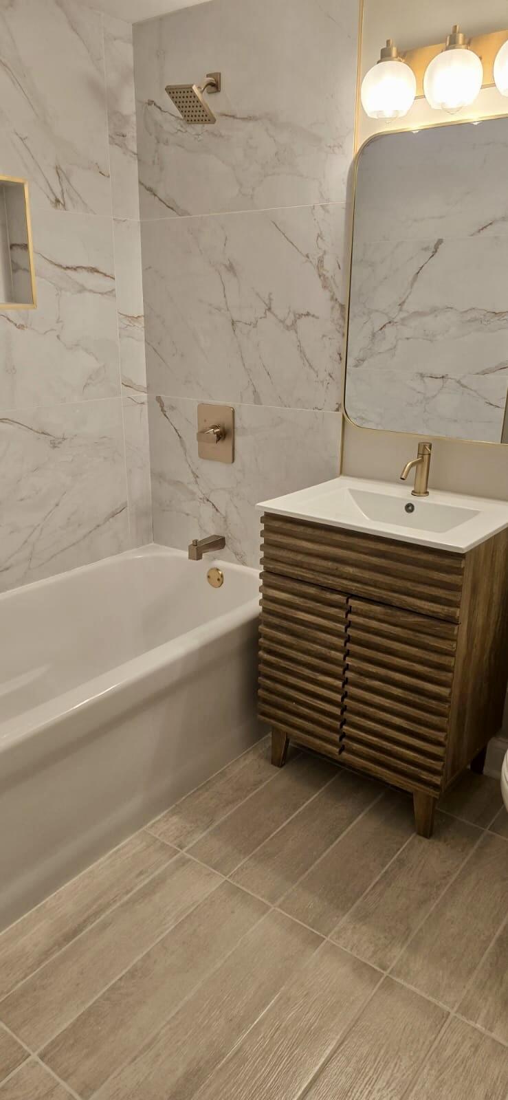 1528 Hanley Street Gary, IN 46406 - Photo 22 of 27 a bathroom with a sink and bathtub
