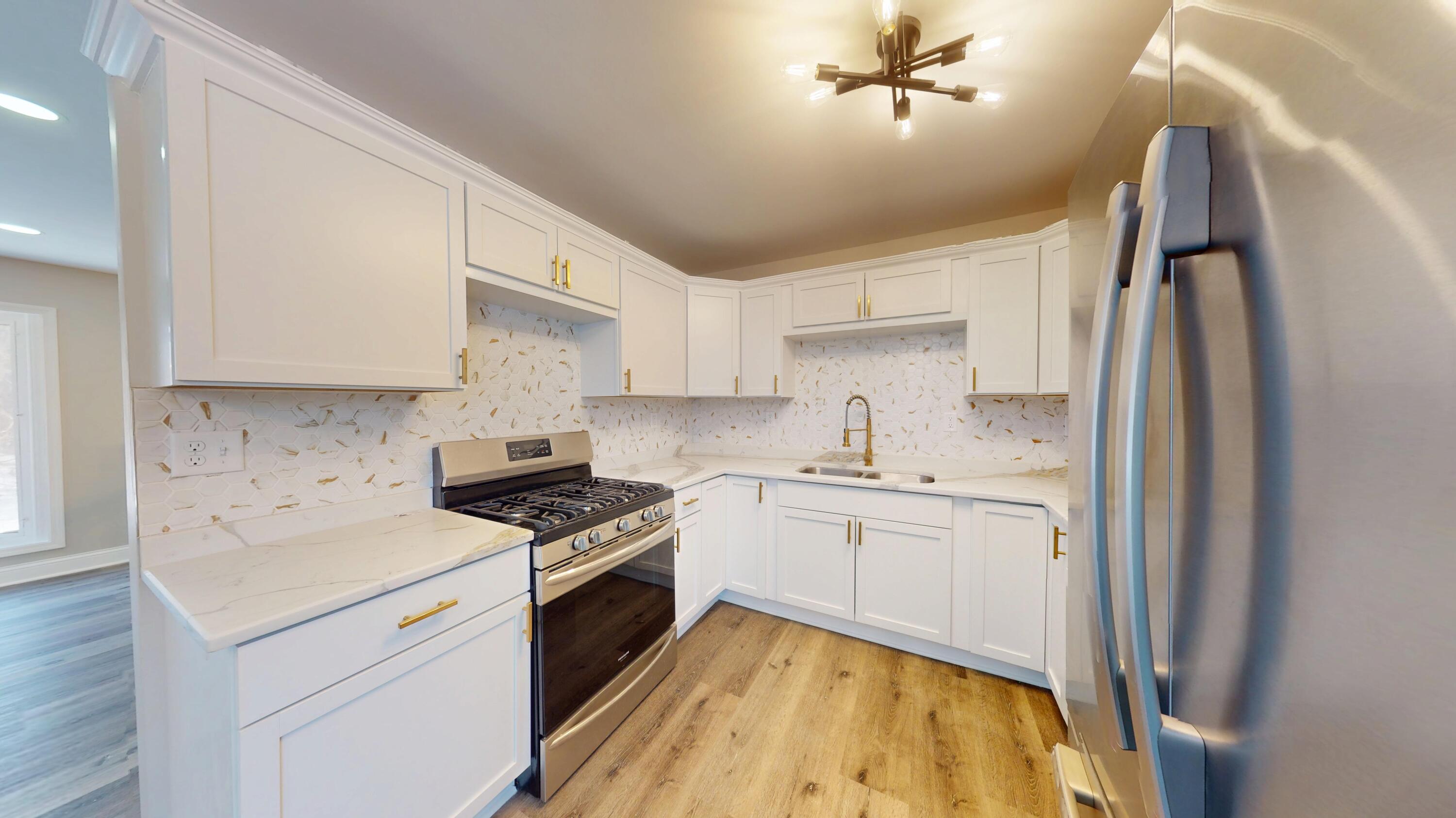 1528 Hanley Street Gary, IN 46406 - Photo 26 of 44 a kitchen with stainless steel appliances granite countertop a sink stove and refrigerator
