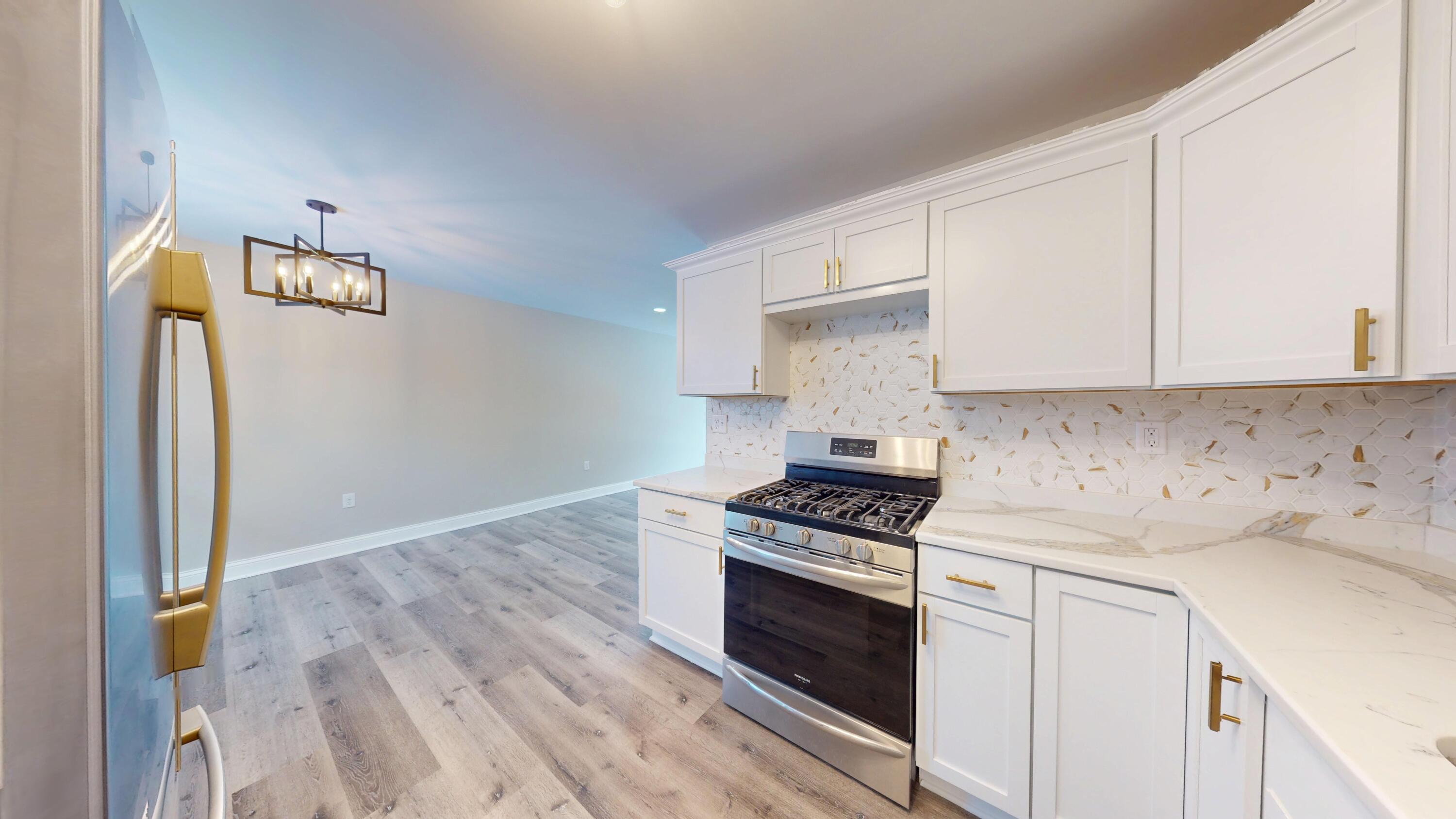 1528 Hanley Street Gary, IN 46406 - Photo 27 of 44 a kitchen with granite countertop a stove and a sink