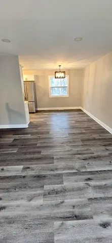 a view of a room with wooden floor and window