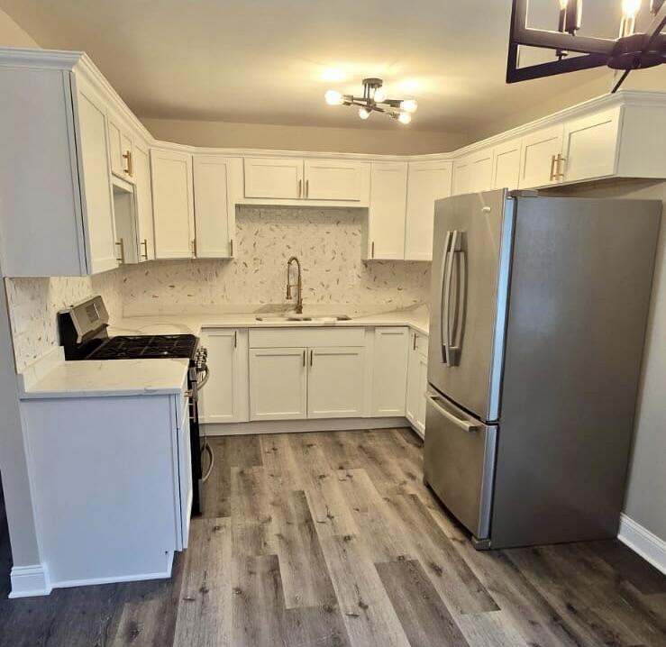 1528 Hanley Street Gary, IN 46406 - Photo 6 of 27 a kitchen with granite countertop a sink appliances a counter space and cabinets