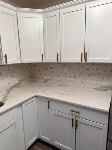 a view of a utility room with closet and dryer