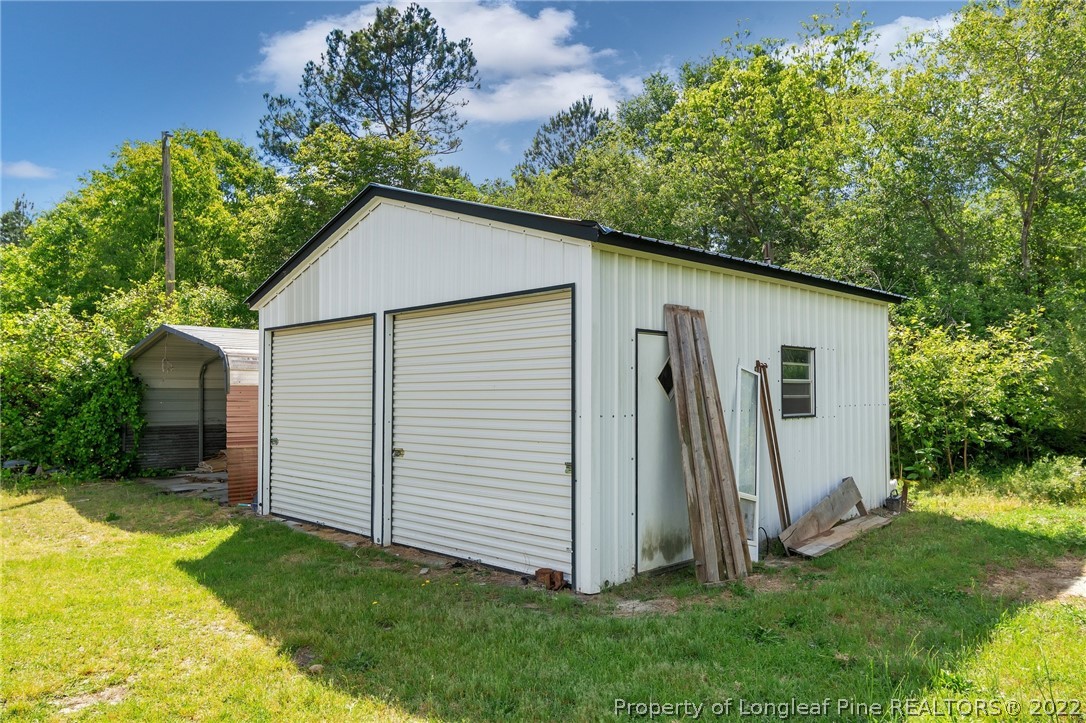 25627 Harris Road Marston, NC 28363 - Photo 26 of 30 a backyard of a house with potted plants and large tree
