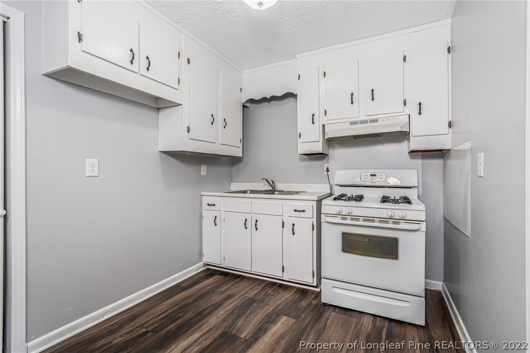 25627 Harris Road Marston, NC 28363 - Photo 10 of 30 a kitchen with cabinets appliances and a wooden floor
