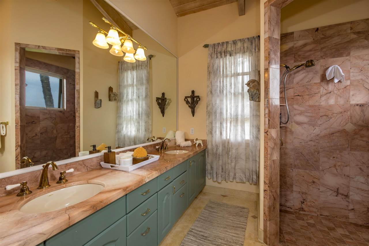 0 East Waipio Road Haiku, HI 96708 - Photo 15 of 30 a bathroom with a double vanity sink and mirror
