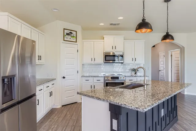 a view of a kitchen with a sink and a stove top oven