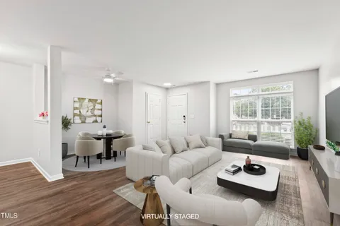 a living room with furniture and a window with wooden floor