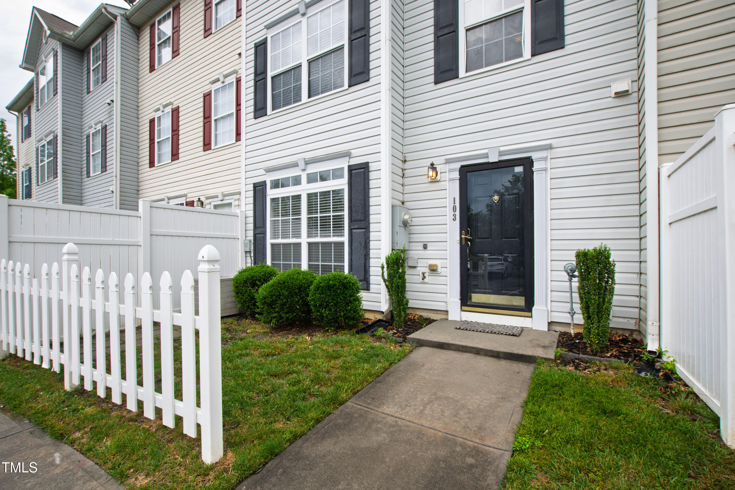 8610 Neuse Landing Lane, Unit 103 Raleigh, NC 27616 - Photo 13 of 28 a front view of a house with a yard
