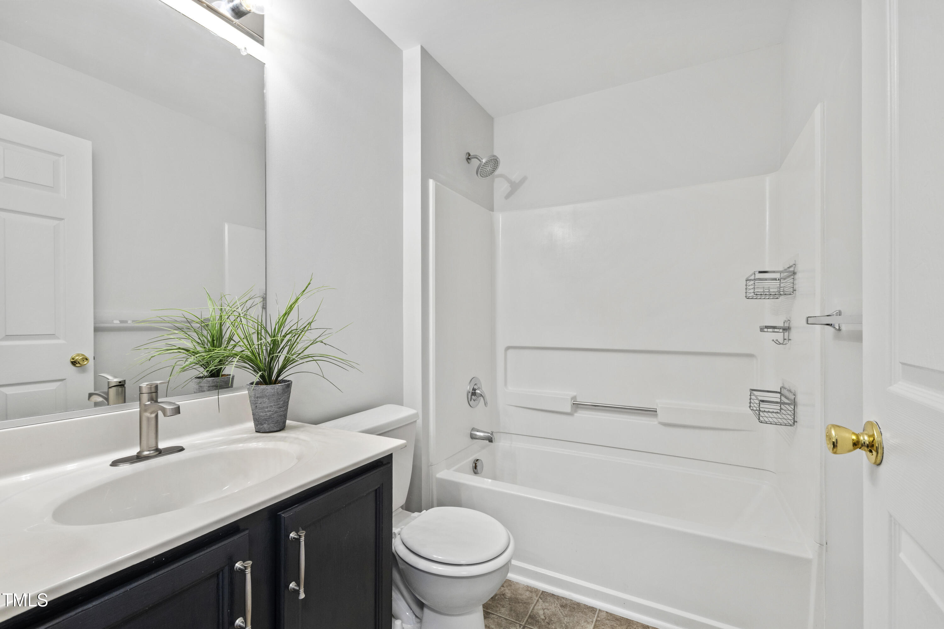 8610 Neuse Landing Lane, Unit 103 Raleigh, NC 27616 - Photo 20 of 28 a bathroom with a granite countertop sink a toilet and shower