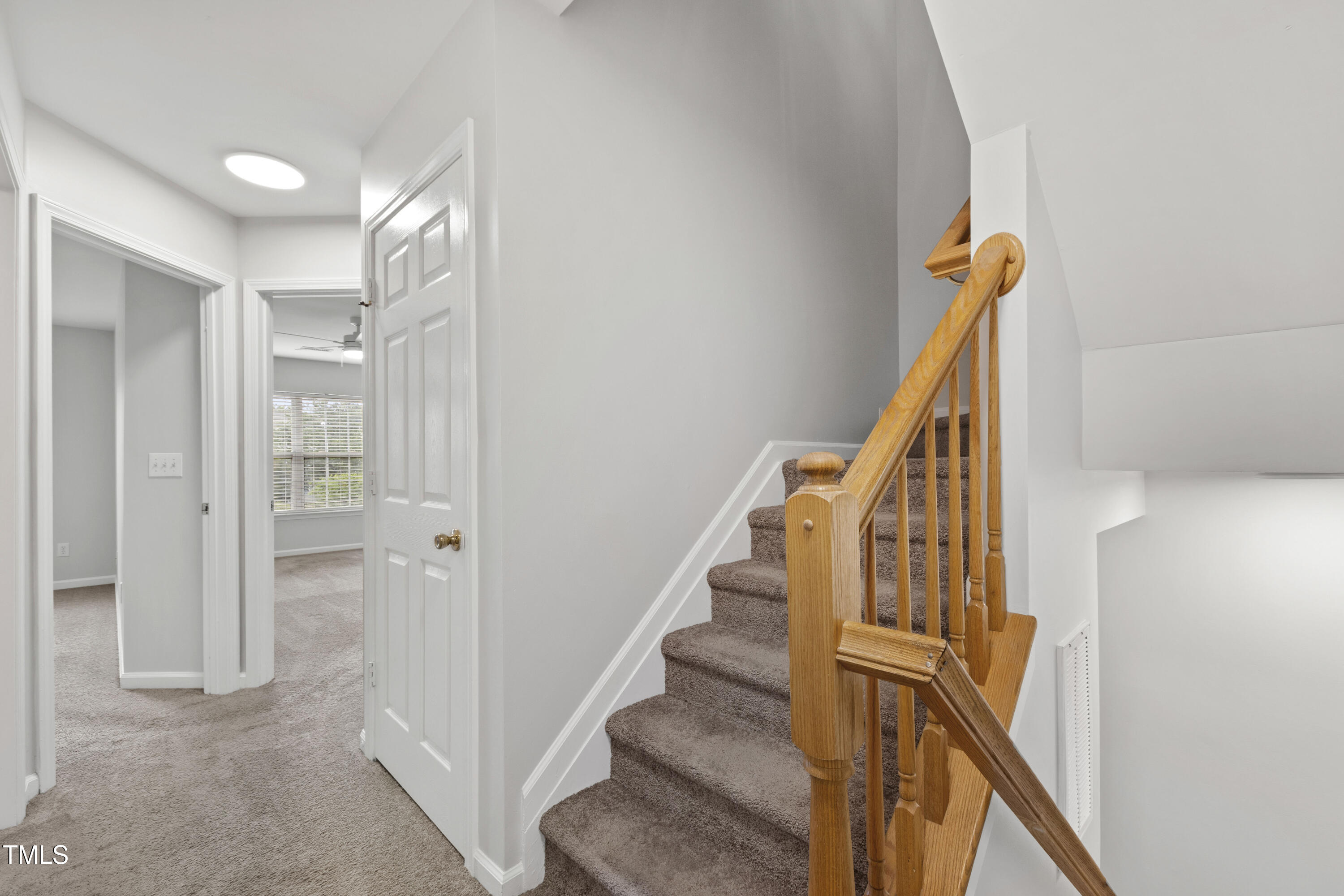 8610 Neuse Landing Lane, Unit 103 Raleigh, NC 27616 - Photo 23 of 28 a view of a hallway with wooden floor and entryway