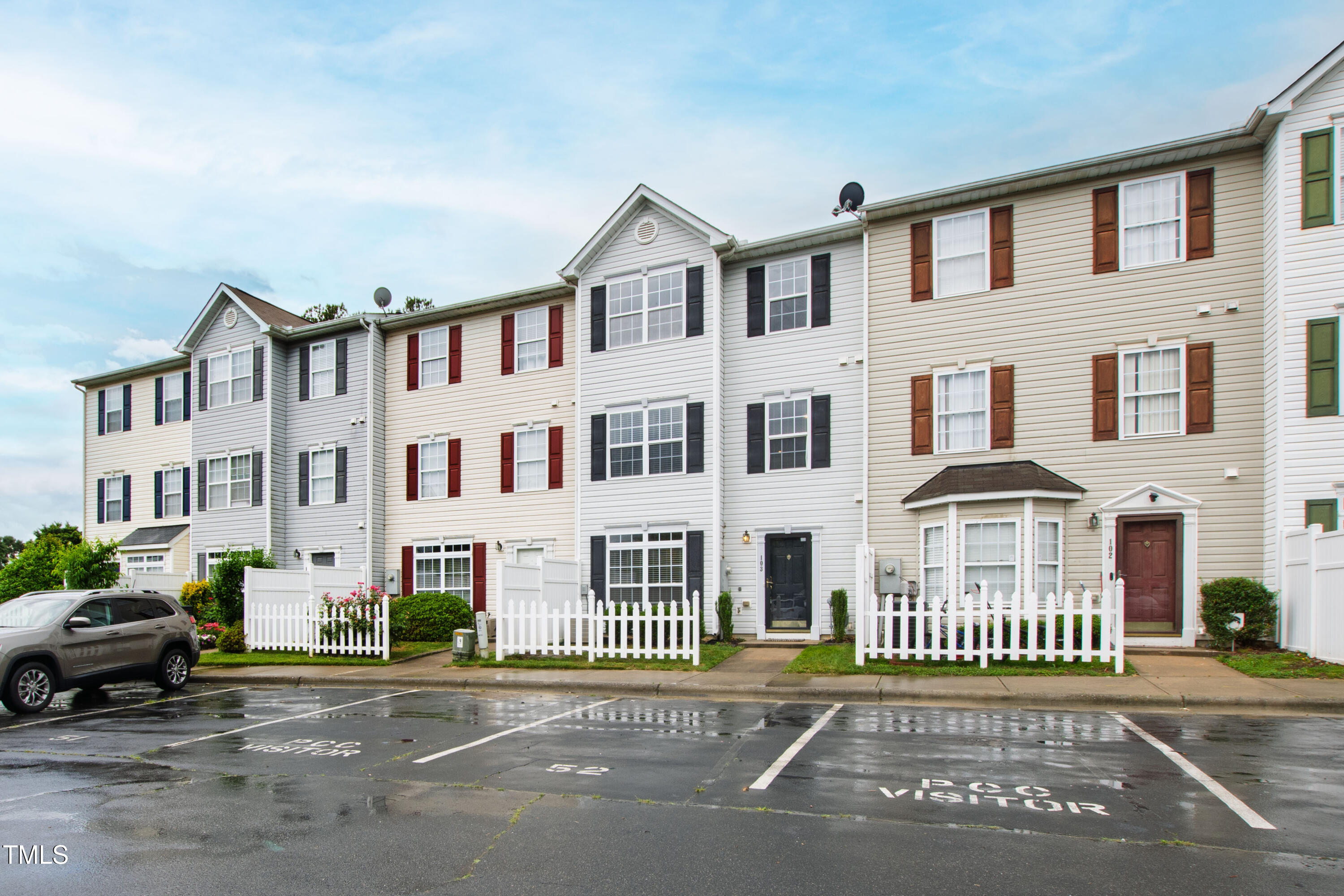 8610 Neuse Landing Lane, Unit 103 Raleigh, NC 27616 - Photo 27 of 28 a front view of a building with a garden