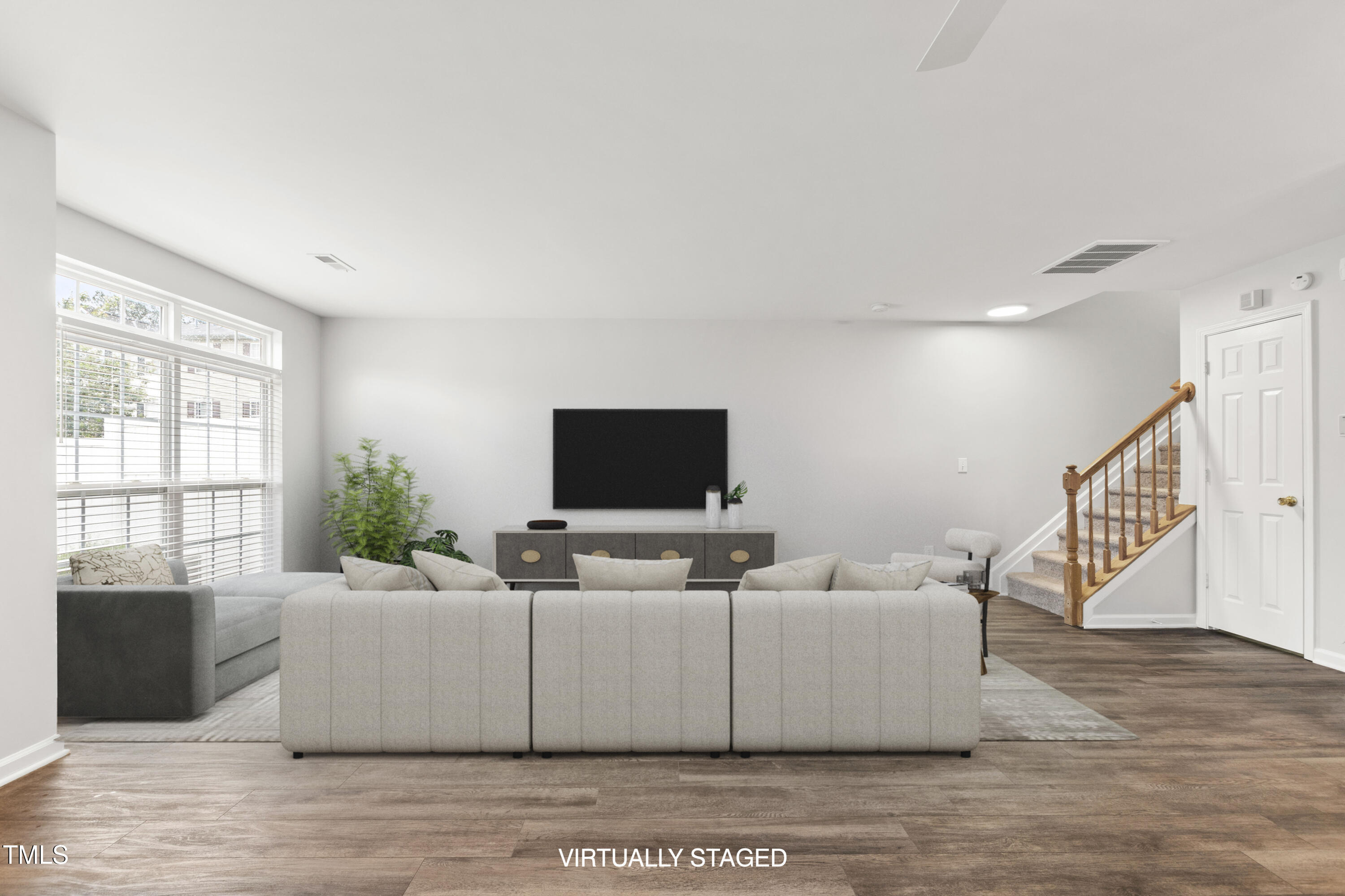 8610 Neuse Landing Lane, Unit 103 Raleigh, NC 27616 - Photo 2 of 28 a living room with furniture and a flat screen tv