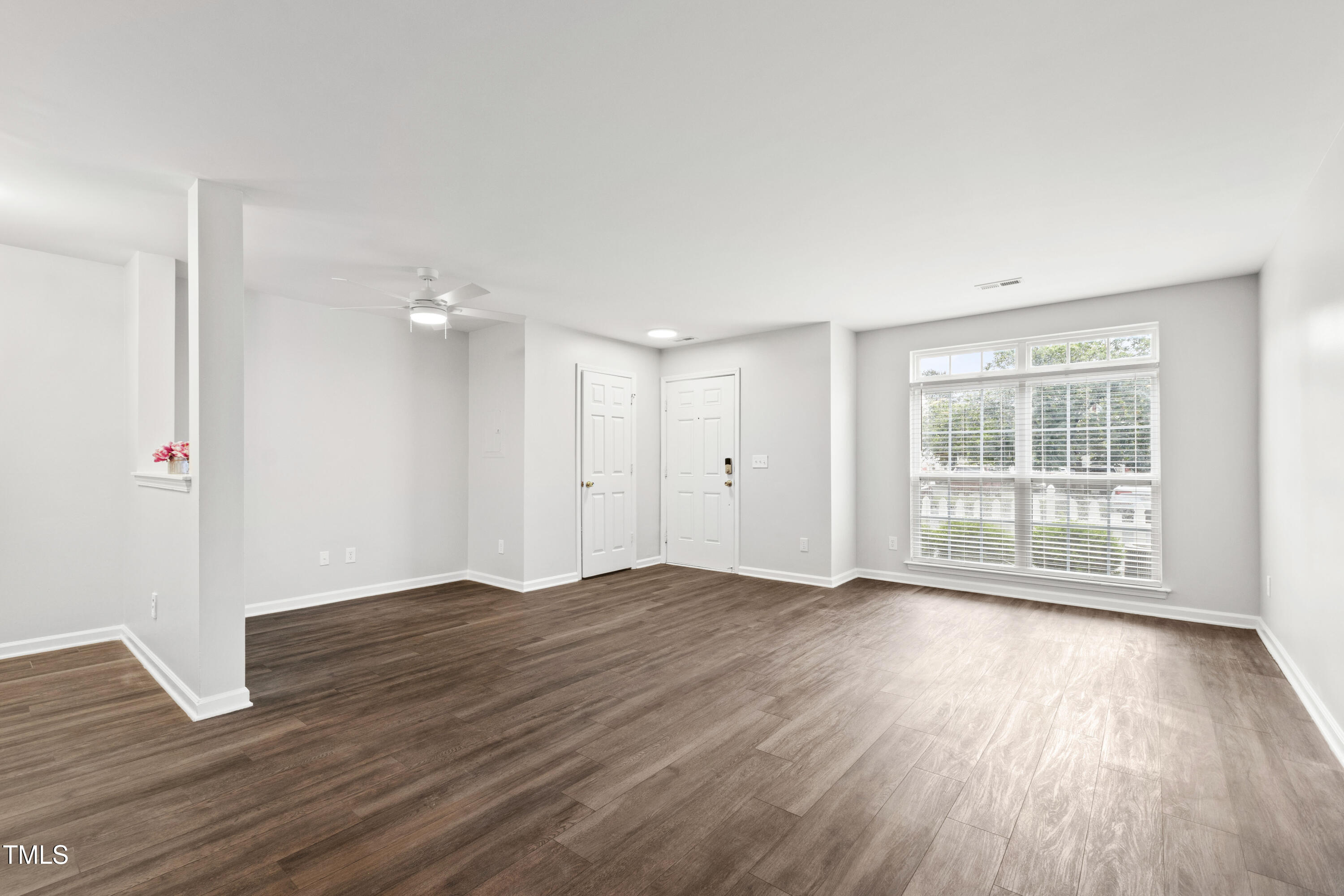 8610 Neuse Landing Lane, Unit 103 Raleigh, NC 27616 - Photo 7 of 28 an empty room with wooden floor and windows