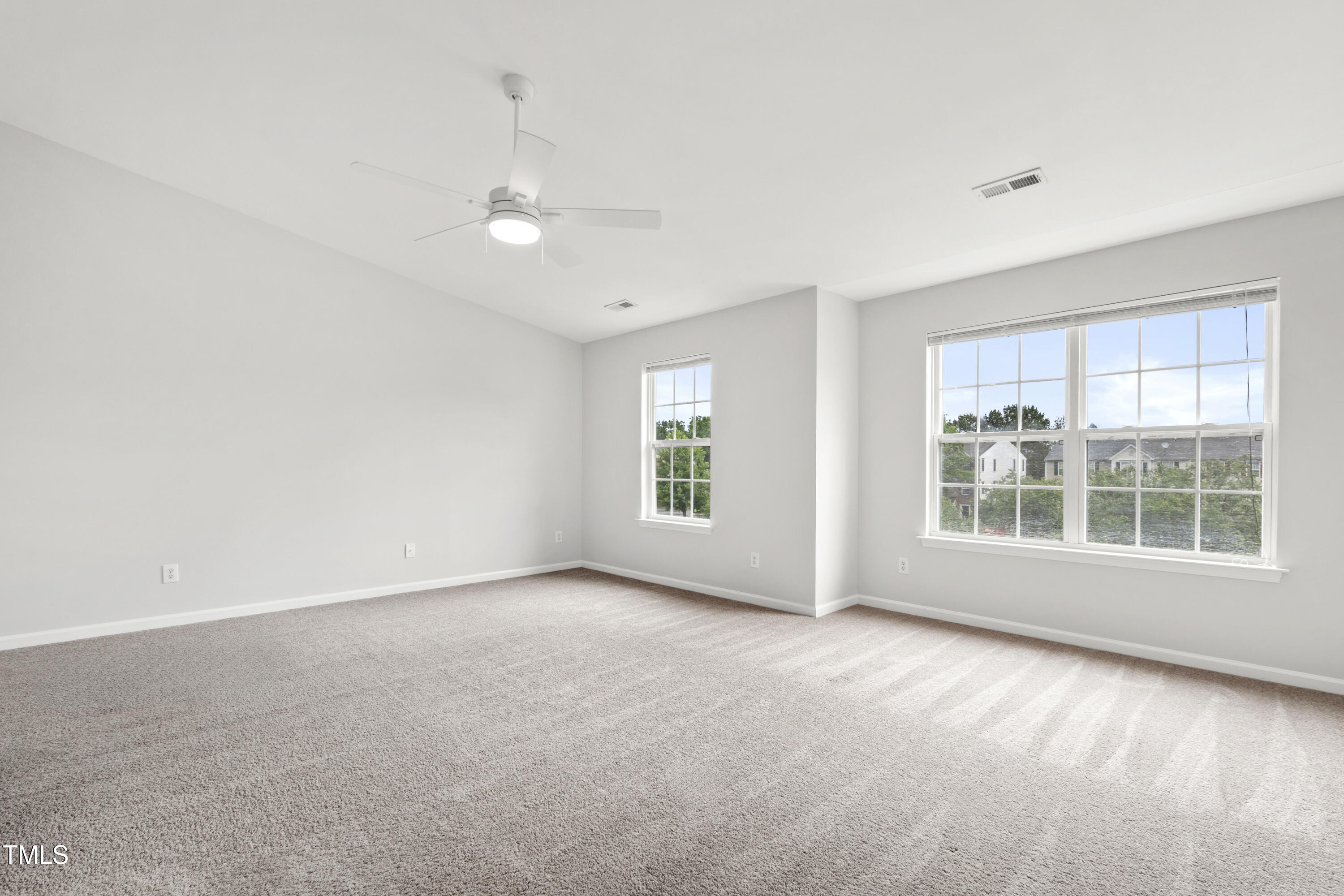 8610 Neuse Landing Lane, Unit 103 Raleigh, NC 27616 - Photo 9 of 28 an empty room with wooden floor and windows