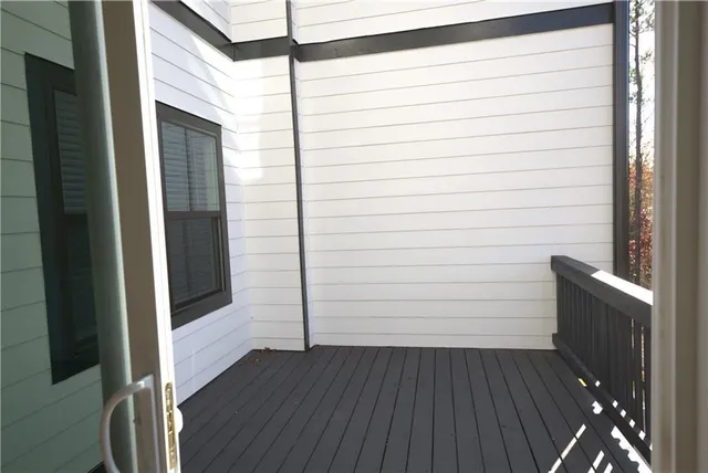 a view of a balcony with wooden fence