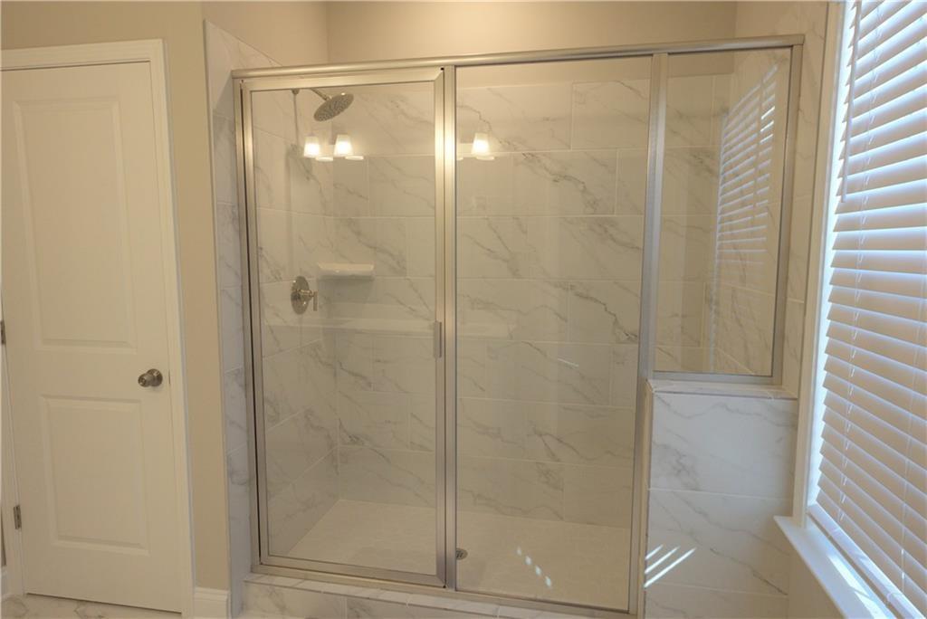 977 Catamaran Court Alpharetta, GA 30005 - Photo 19 of 39 a bathroom with a glass shower door