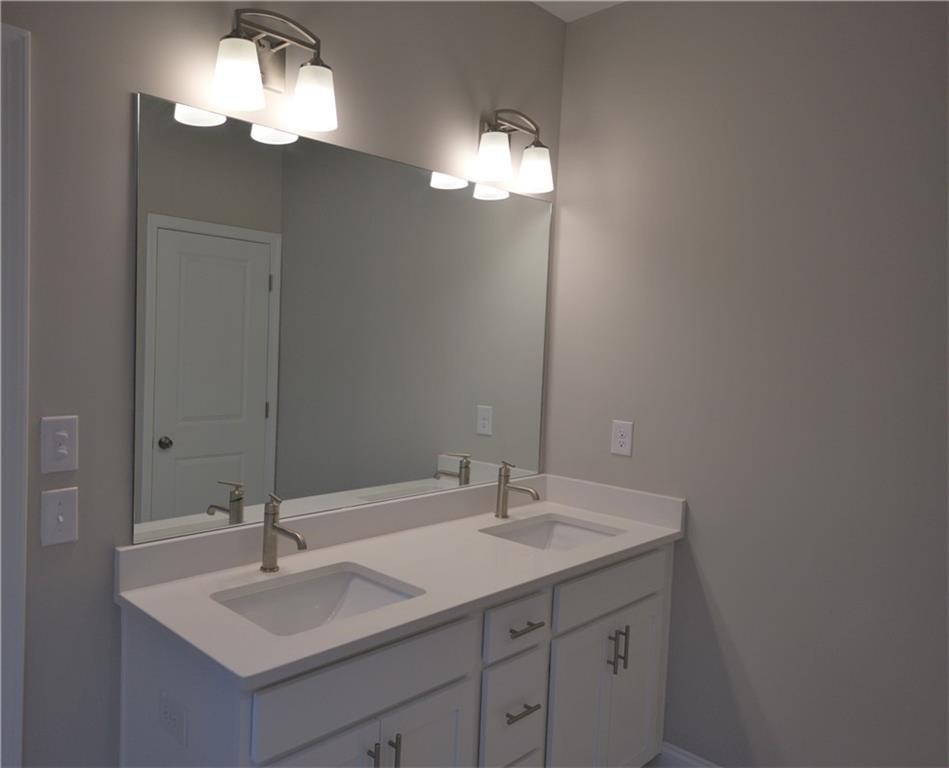 977 Catamaran Court Alpharetta, GA 30005 - Photo 20 of 39 a bathroom with a sink and a mirror
