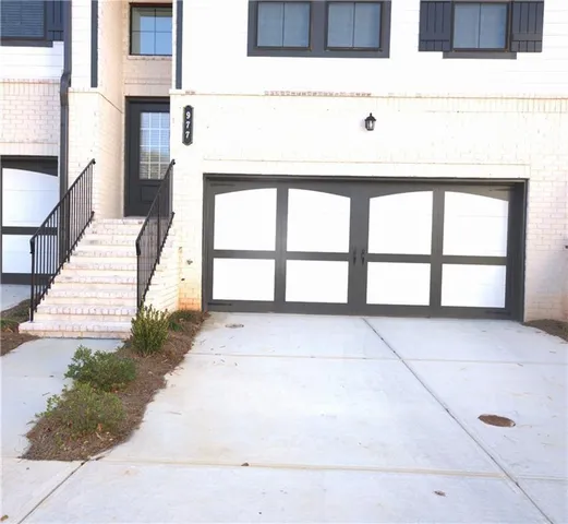 a view of empty room with kitchen and stove