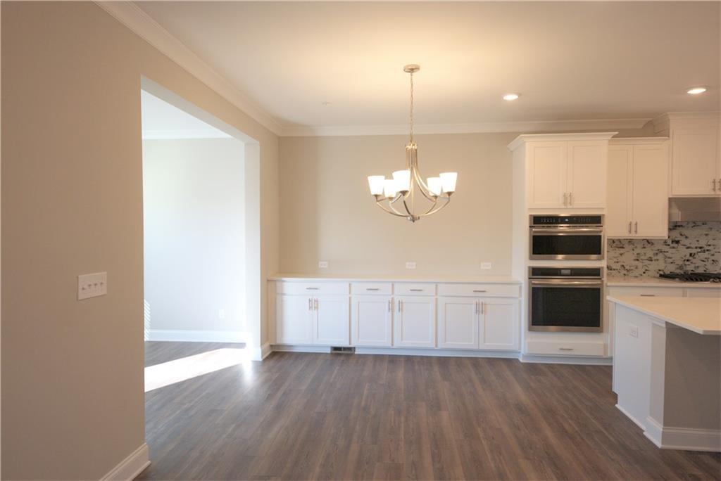 977 Catamaran Court Alpharetta, GA 30005 - Photo 3 of 39 a view of empty room with kitchen and stove