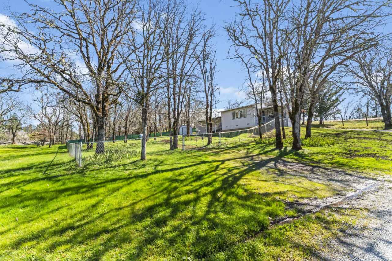 650 Three Pines Road Grants Pass, OR 97526 - Photo 2 of 48 a view of yard with swimming pool and green space