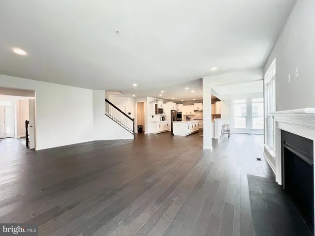 a view of an empty room and wooden floor
