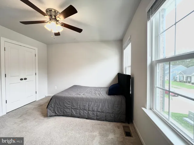 a bedroom with a bed and window
