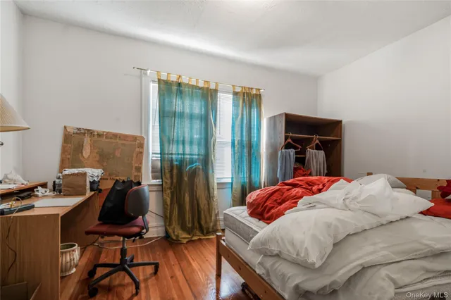 a bedroom with a bed and large windows