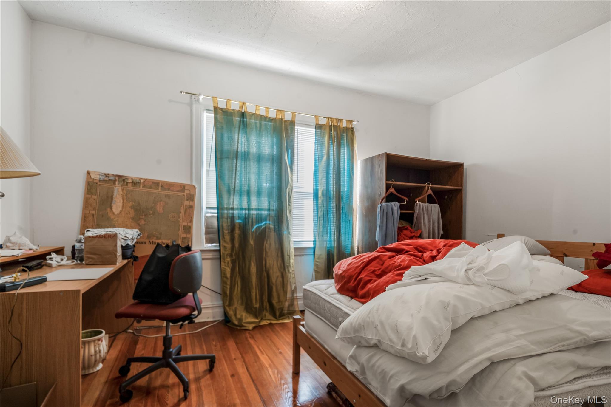 104-37 125th Street Queens, NY 11419 - Photo 12 of 24 a bedroom with a bed and large windows