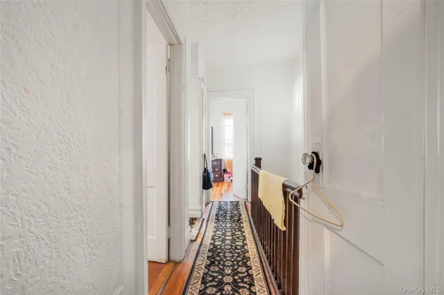 a view of hallway with wooden floor