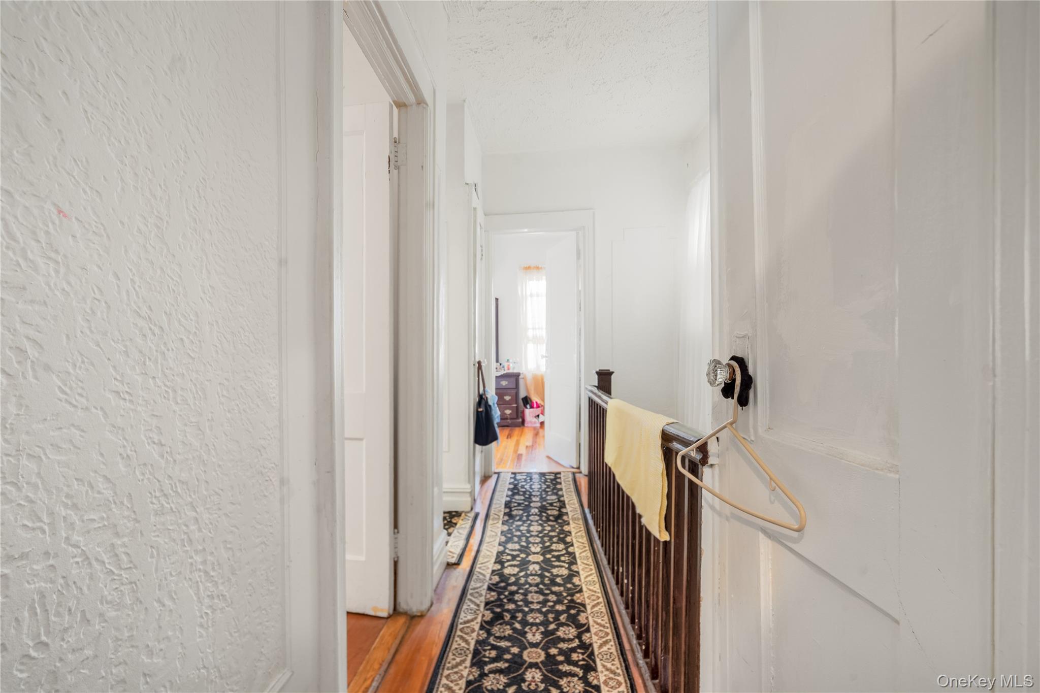 104-37 125th Street Queens, NY 11419 - Photo 14 of 24 a view of hallway with wooden floor