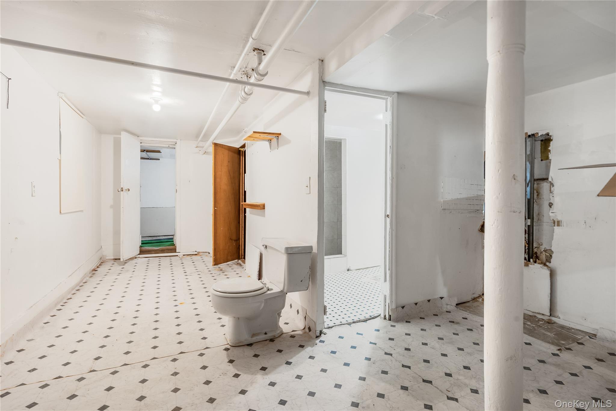 104-37 125th Street Queens, NY 11419 - Photo 15 of 24 a bathroom with a sink and a shower