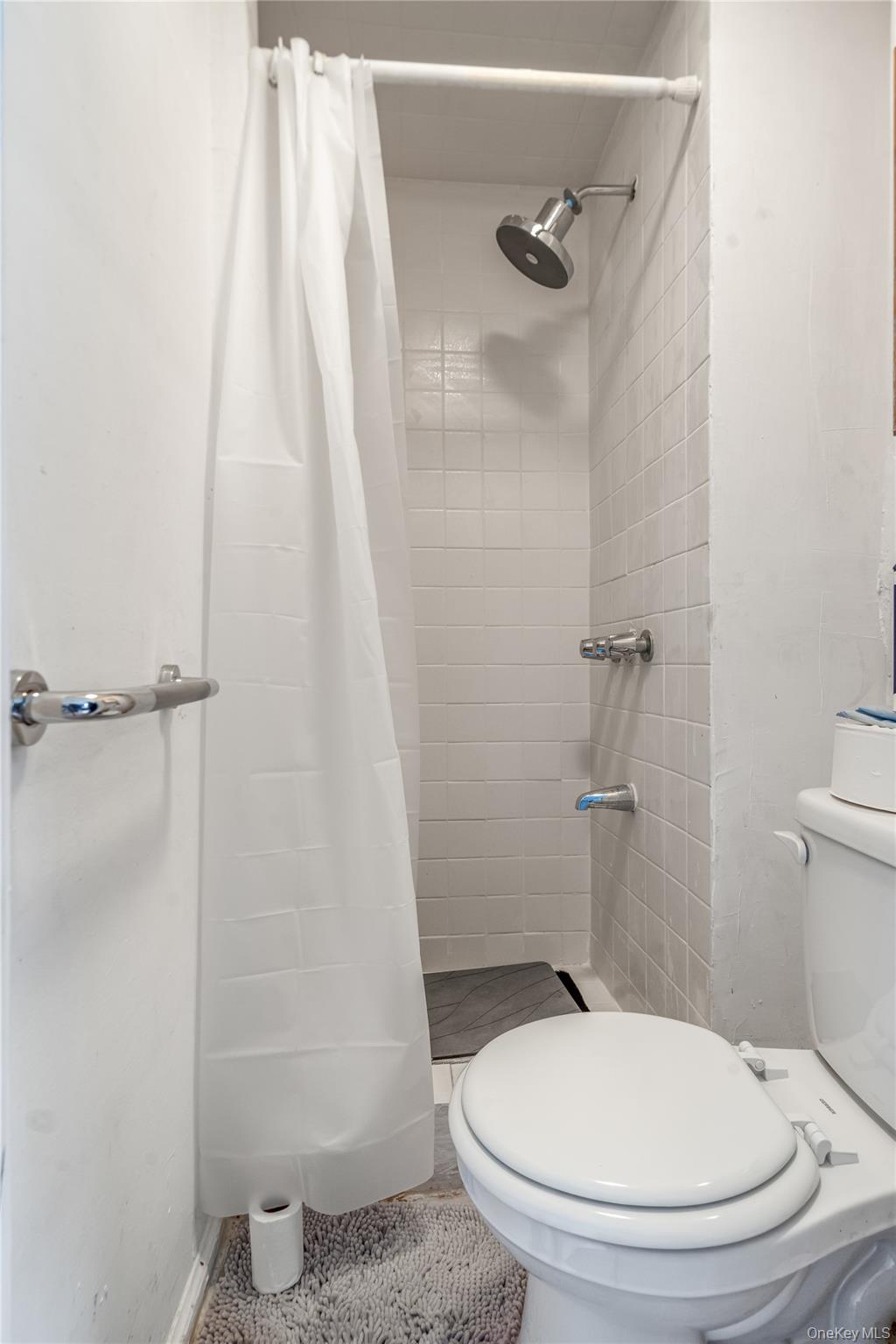 104-37 125th Street Queens, NY 11419 - Photo 18 of 24 a bathroom with a toilet and a shower