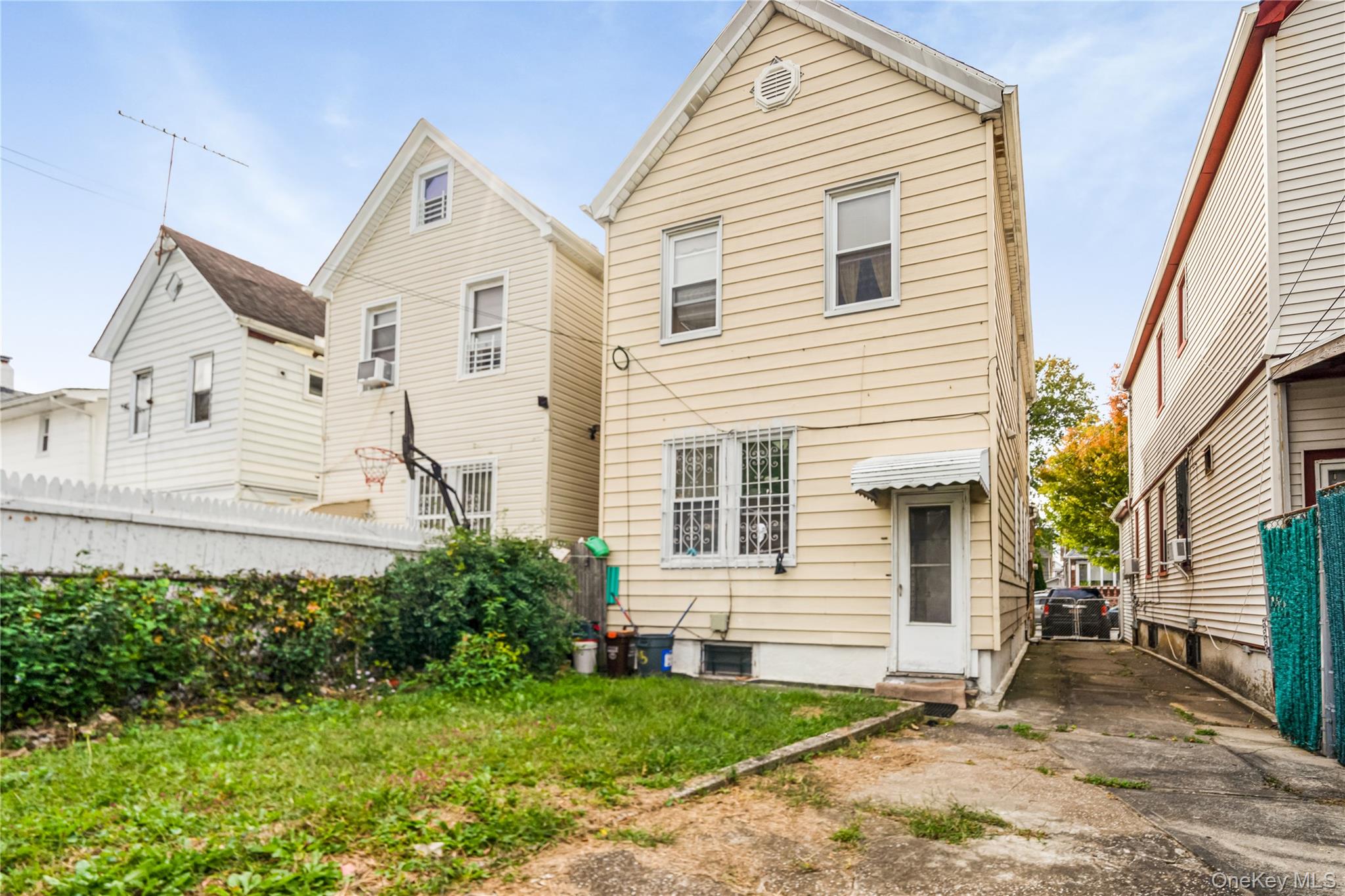 104-37 125th Street Queens, NY 11419 - Photo 20 of 24 a view of a white house next to a yard and potted plants