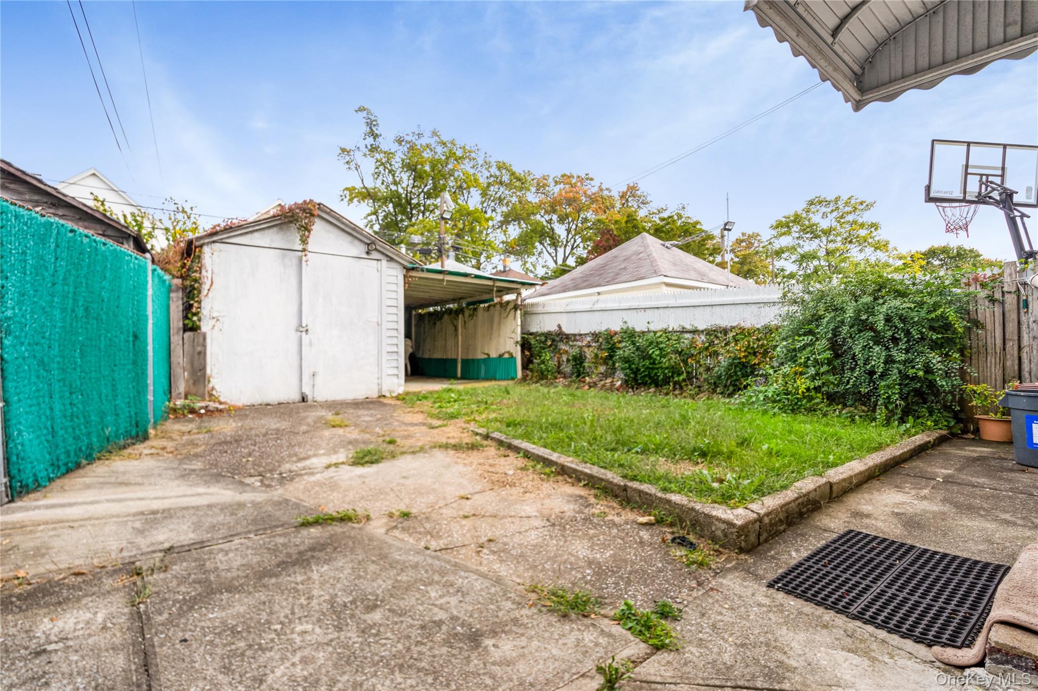 104-37 125th Street Queens, NY 11419 - Photo 22 of 24 a front view of a house with garden